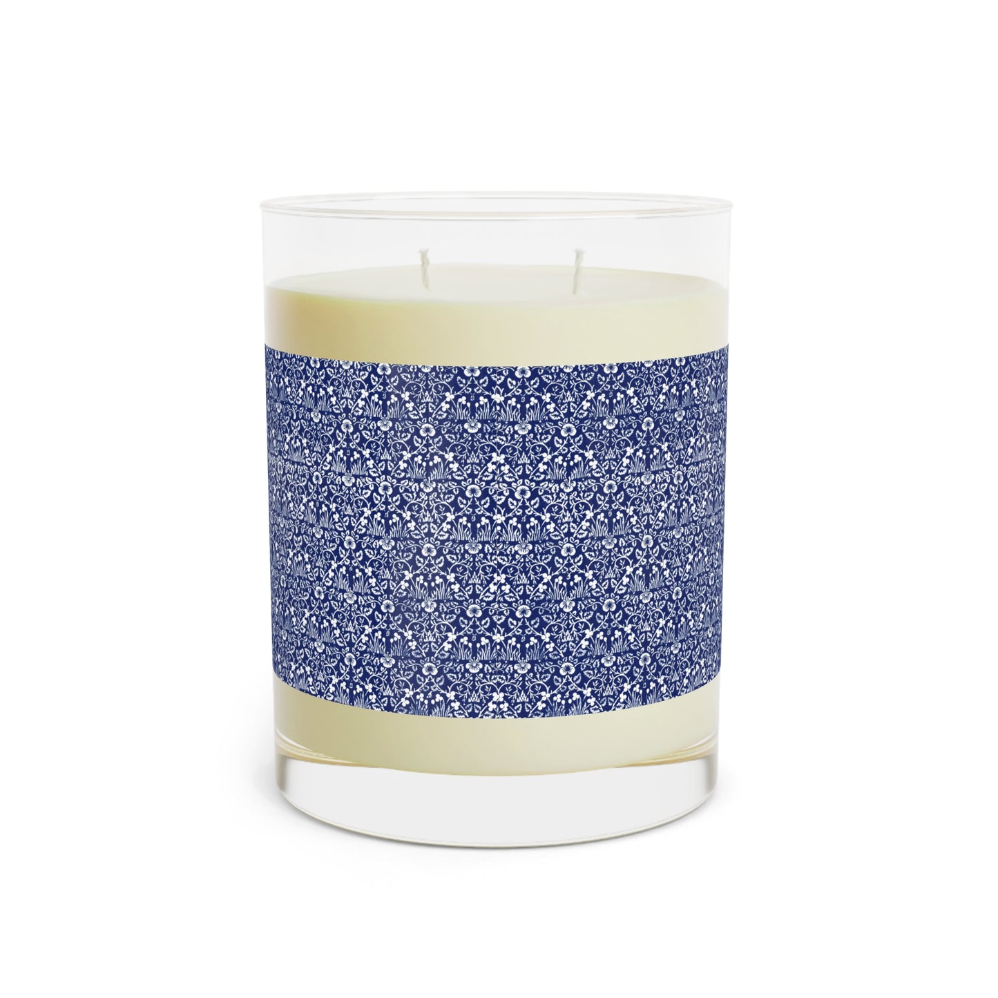 Candle in a glass jar with a blue patterned label on a white background