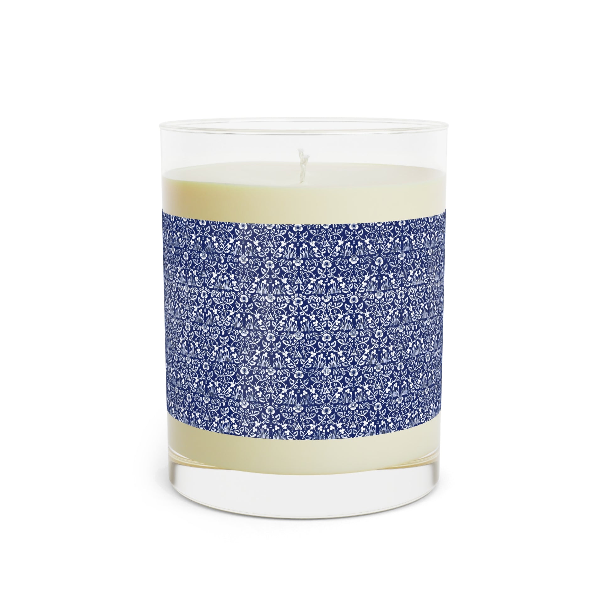 Candle in a glass jar with blue patterned band on a white background