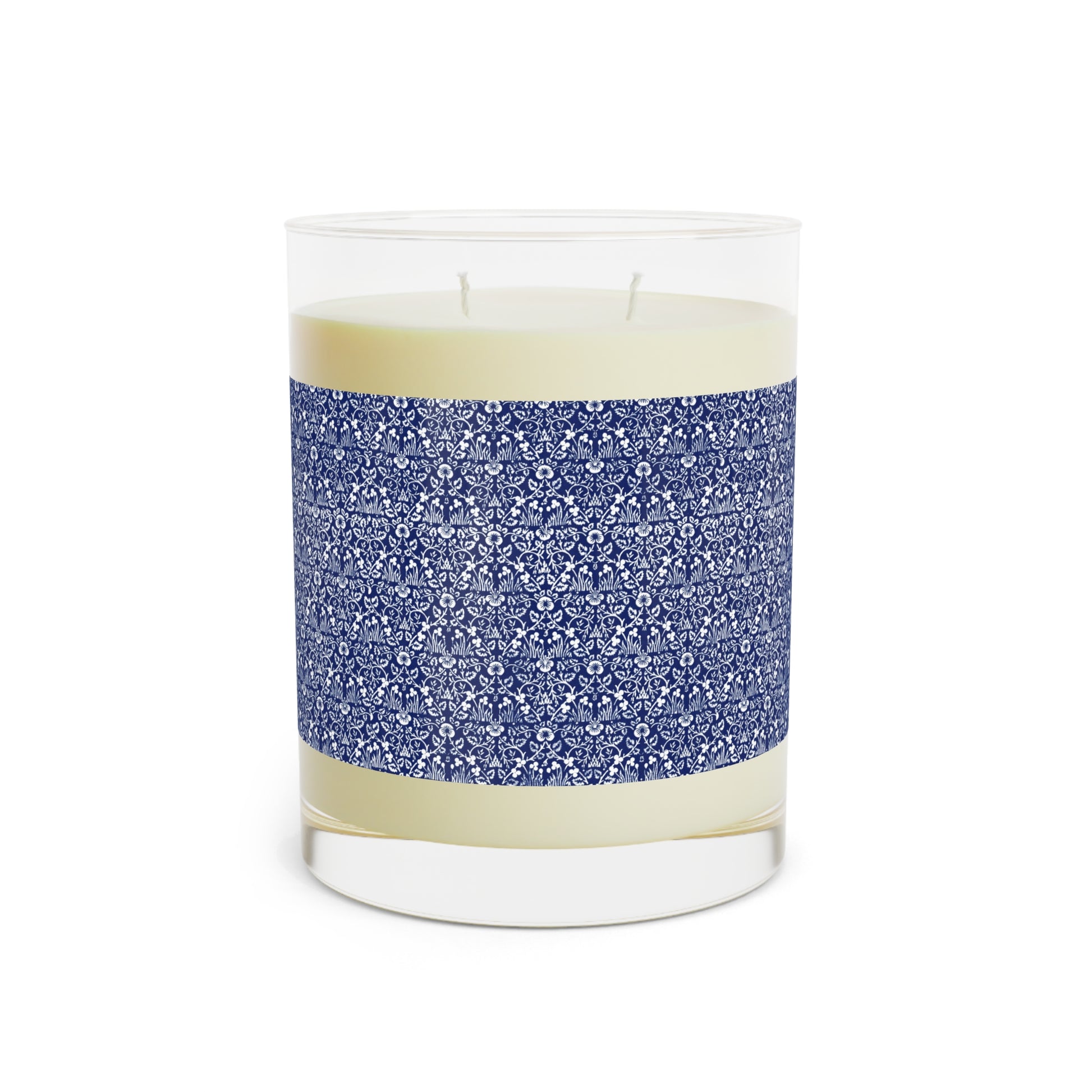 Candle in a glass jar with blue patterned band on a white background
