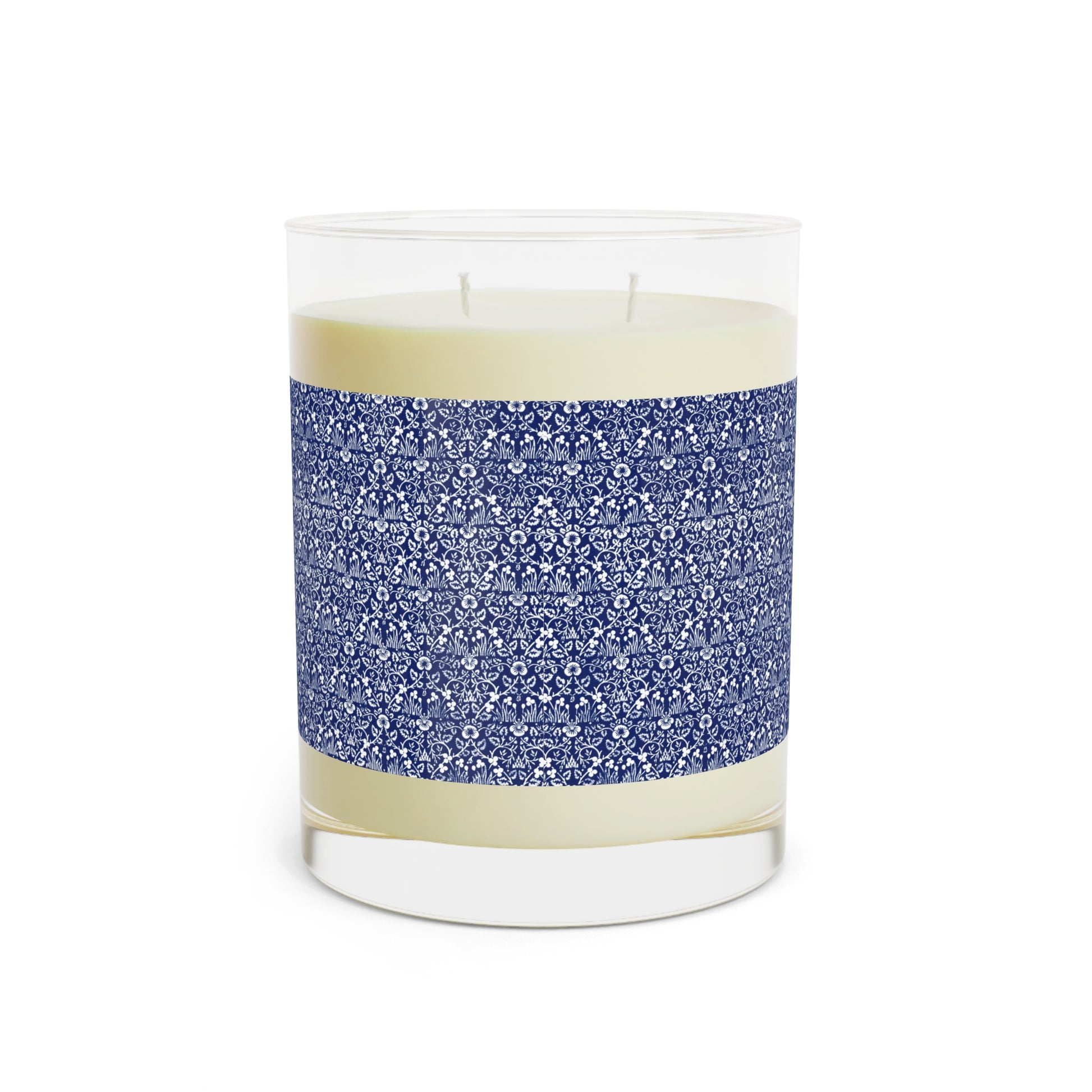 Candle in a glass jar with a blue patterned label on a white background