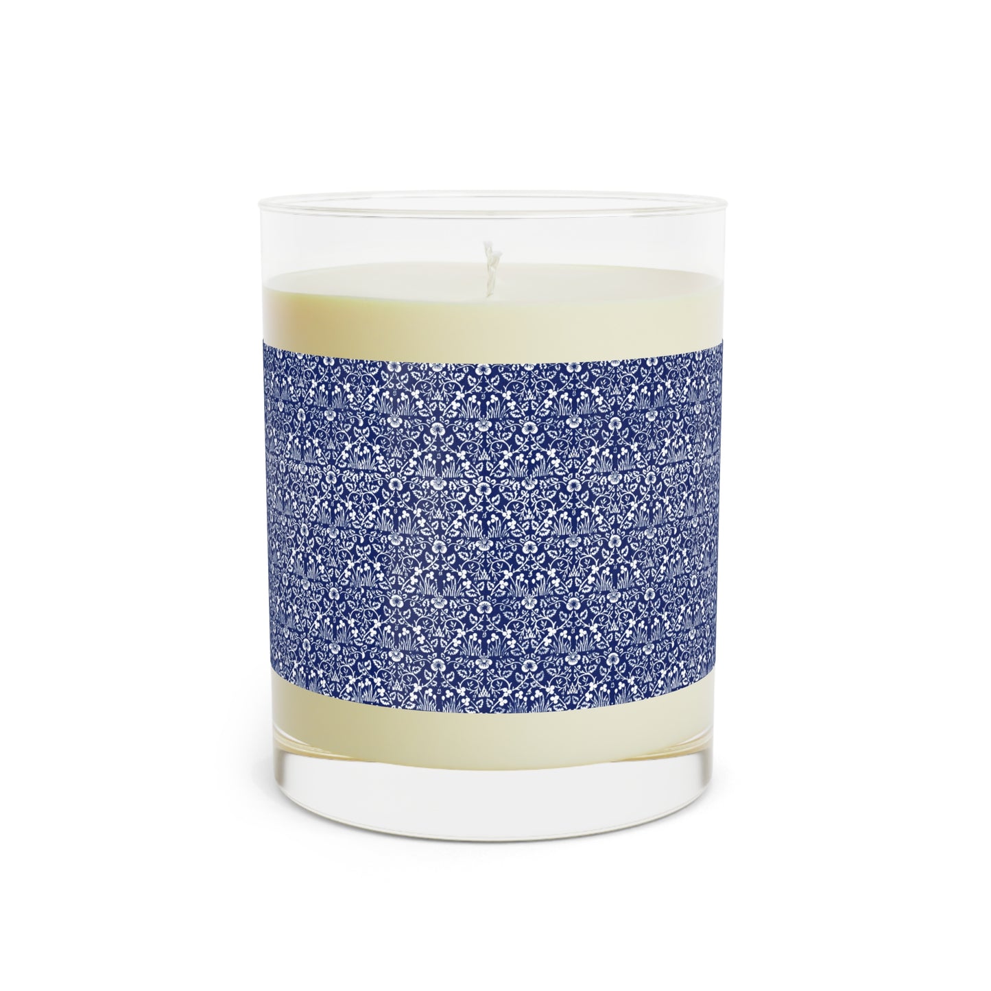 Candle in a glass jar with blue patterned band on a white background