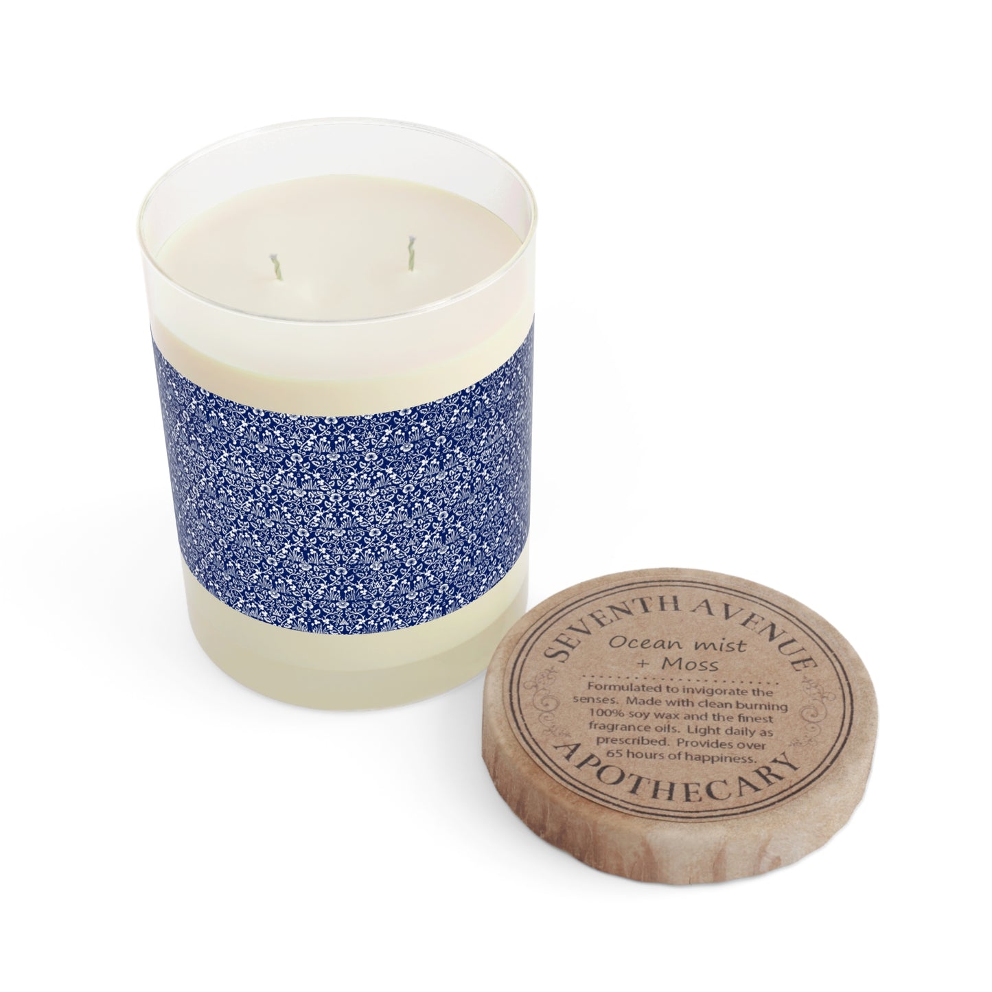 Candle with blue and white design and wooden lid on a white background