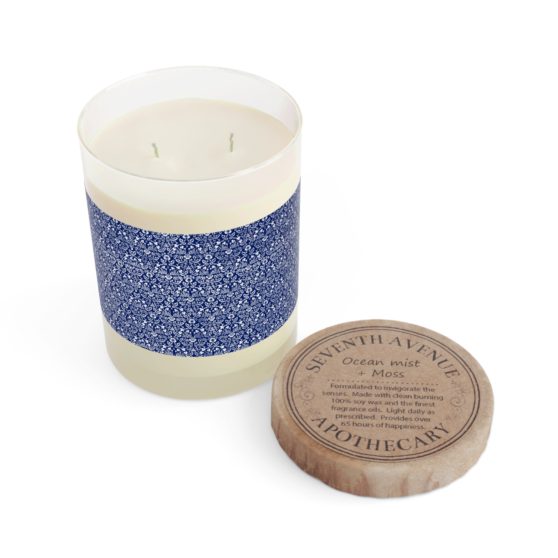 Candle with blue and white design and wooden lid on a white background
