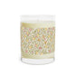 Candle with a floral patterned label on a white background