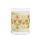 Candle with floral patterned label on a white background