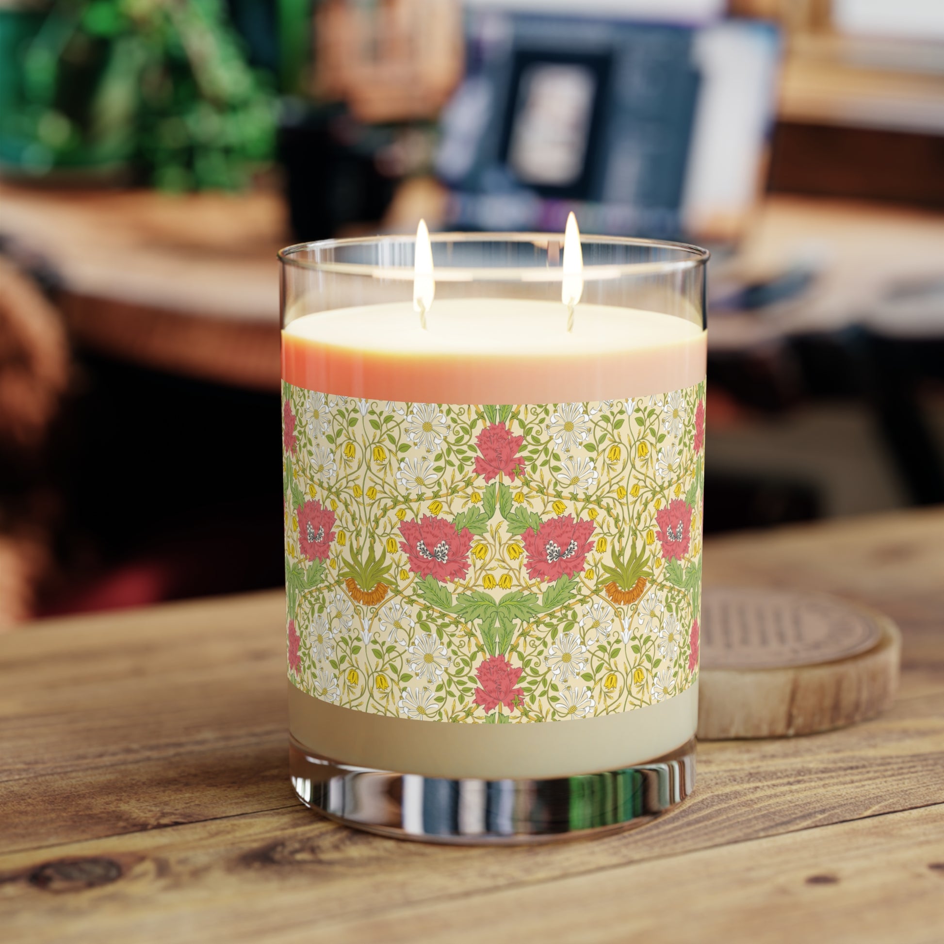 Candle with a decorative label on a wooden surface