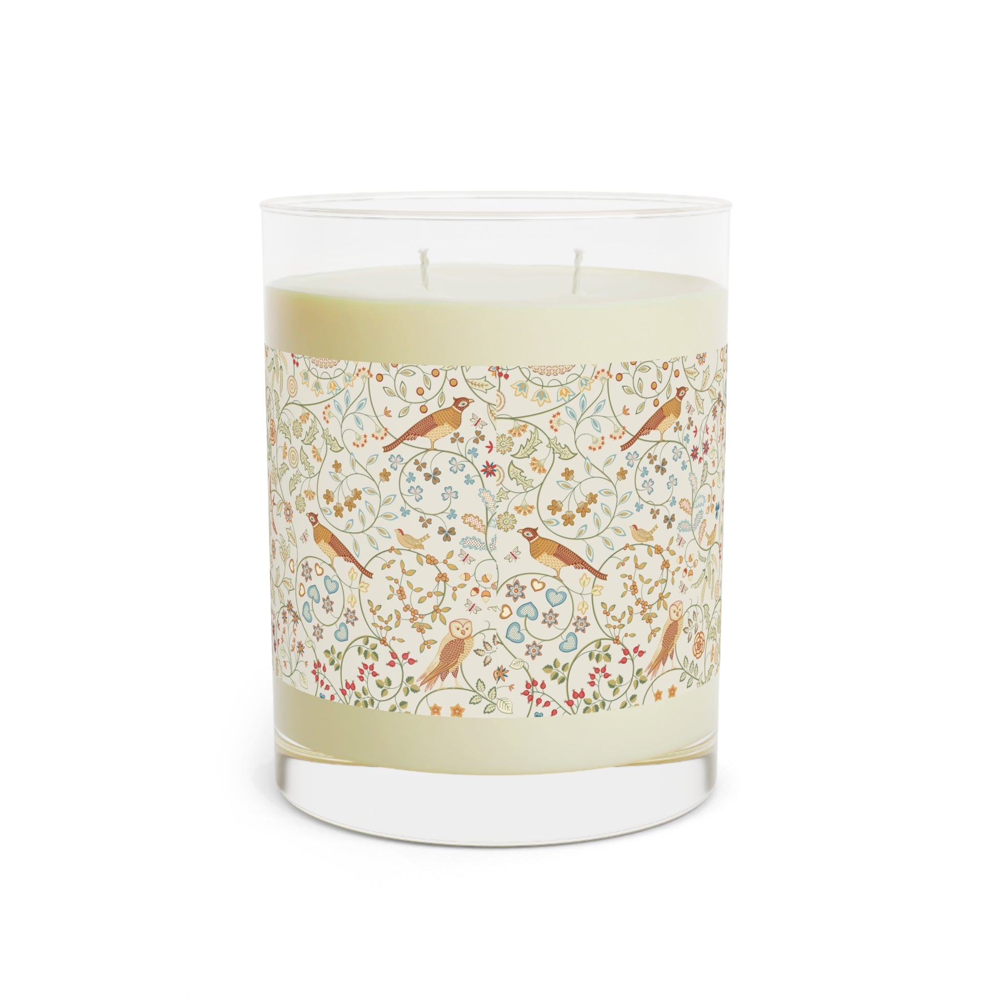Candle with decorative label featuring birds and flowers on a white background