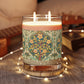 A luxury scented candle with a William Morris & Co floral pattern wrapping around the glass jar, alongside a brown cardboard lid.