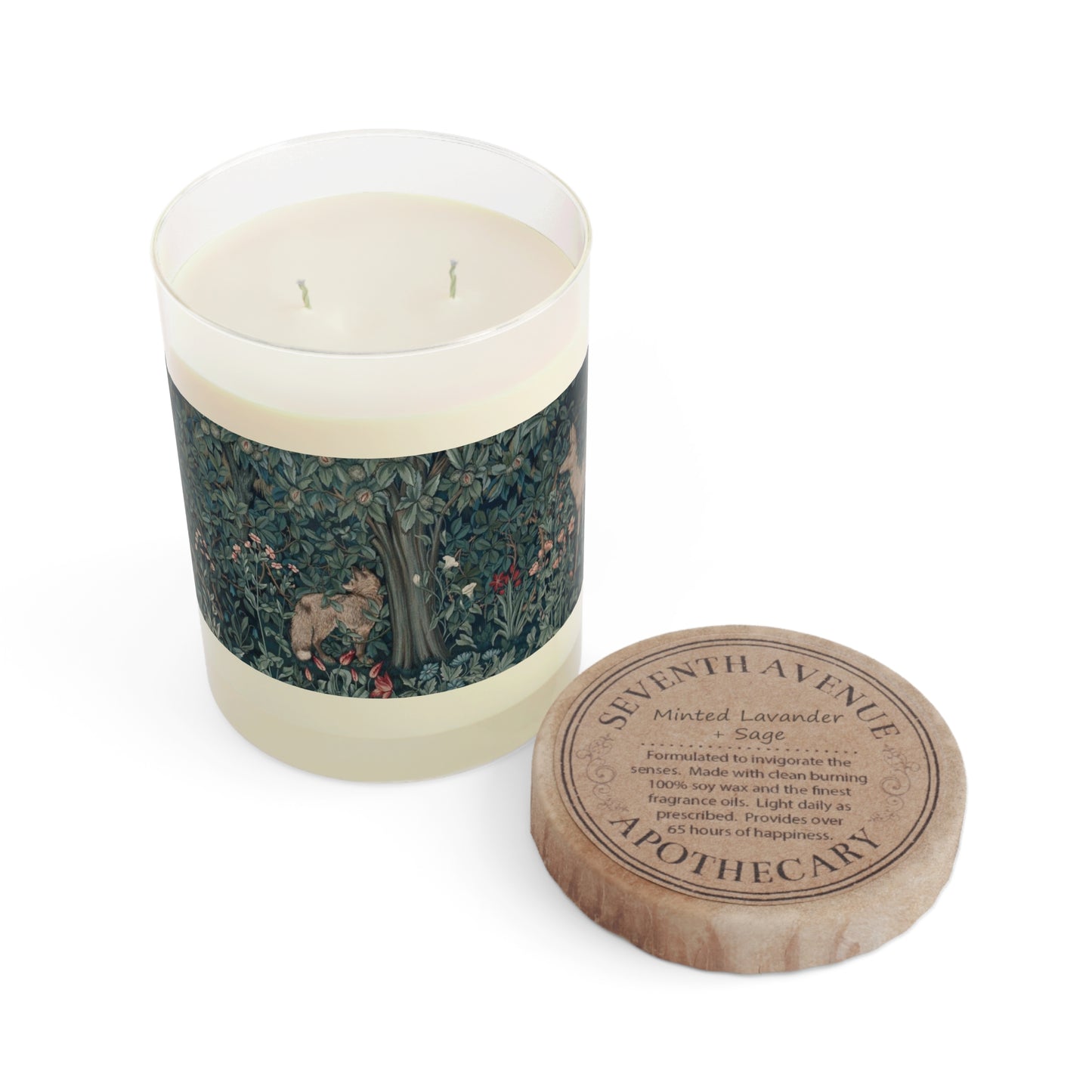 A clear glass scented candle with a brown wax lid featuring a printed design inspired by William Morris's tapestry. The candle is labeled 'Seventh Ave White Tea & Fig'.