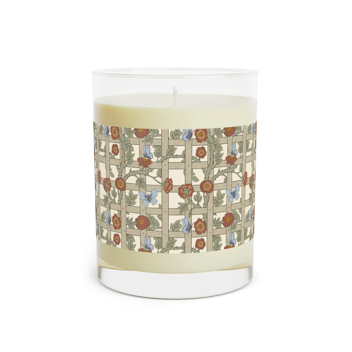 A clear glass jar candle with pale cream wax and a wraparound floral trellis label featuring red flowers, green leaves, and small blue butterflies on a light beige background.
