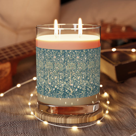 A luxury scented candle with a teal floral William Morris & Co pattern on the jar, alongside a vintage brown cardboard lid.