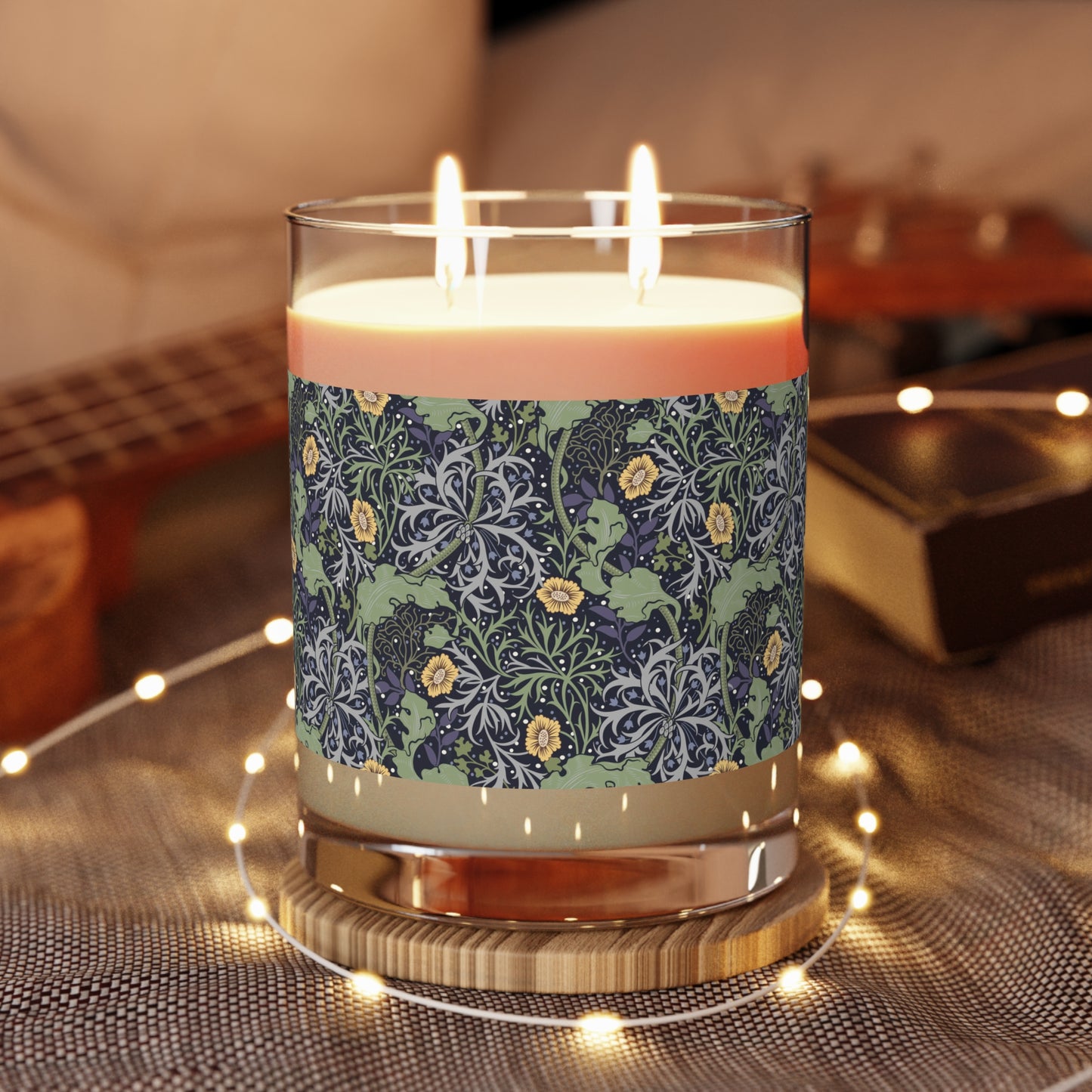A luxury scented soy wax candle in a glass jar with a William Morris floral pattern wrapping around the glass jar, labeled 'Seaweed Collection (Yellow Flower)'