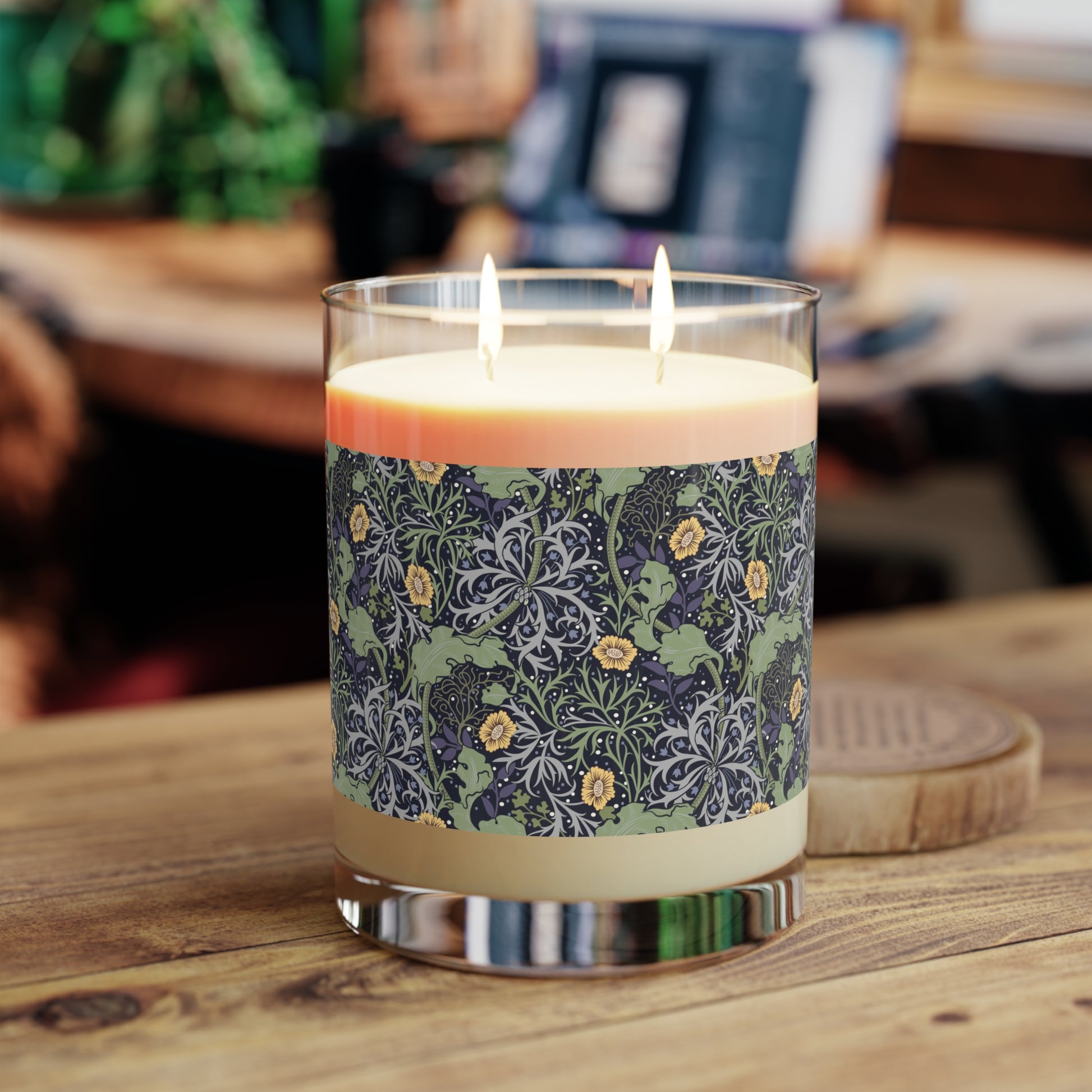 A luxury scented soy wax candle in a glass jar with a William Morris floral pattern wrapping around the glass jar, labeled 'Seaweed Collection (Yellow Flower)'