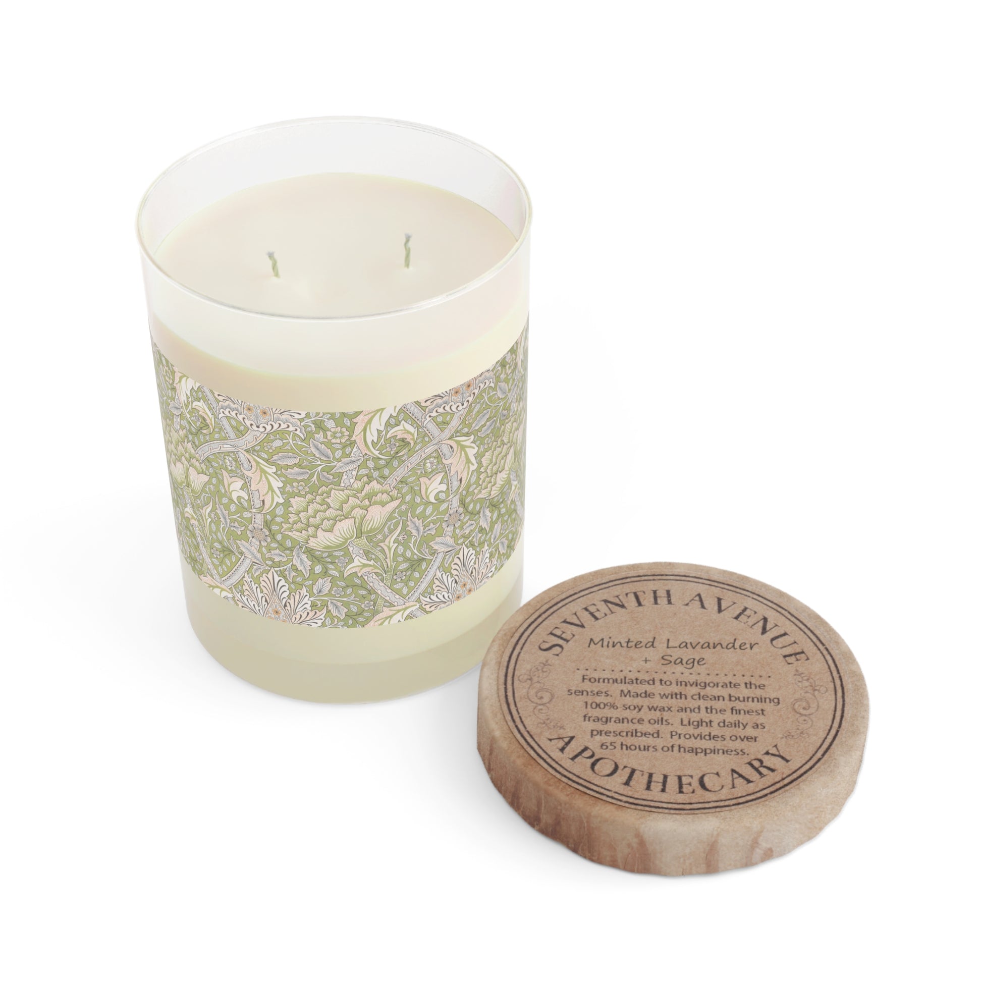 A luxury scented candle with a green and brown William Morris & Co floral patterned wrap around it, labeled 'Brook' from the Windrush Collection. The candle is in a clear jar with a brown cardboard lid.