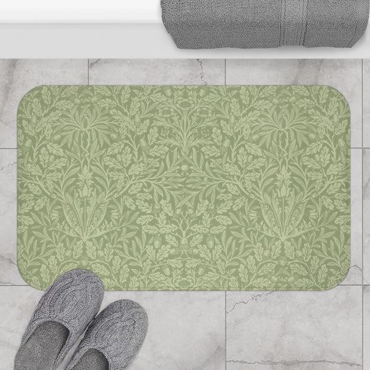 A rectangular green microfibre bath mat with a floral pattern inspired by William Morris - Acorns & Oak Leaves Collection.