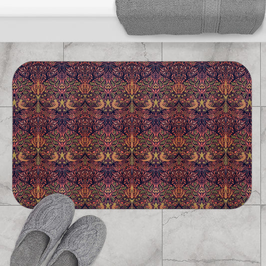 Decorative bath mat with a colourful pattern on a tiled floor with slippers and a bath mat.