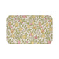 Floral patterned mat with yellow flowers and green leaves on a white background