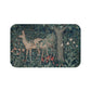 A microfibre bath mat featuring an intricate design of a deer in a forest setting, inspired by the William Morris tapestry.