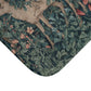 A microfibre bath mat featuring an intricate design of a deer in a forest setting, inspired by the William Morris tapestry.