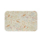 A microfibre bath mat with a floral and bird pattern inspired by William Morris, in a beige, green, and brown color palette.