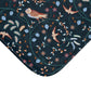 Patterned fabric with birds and flowers on a dark blue background