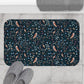 Decorative doormat with owl and floral pattern on a tiled floor with slippers.