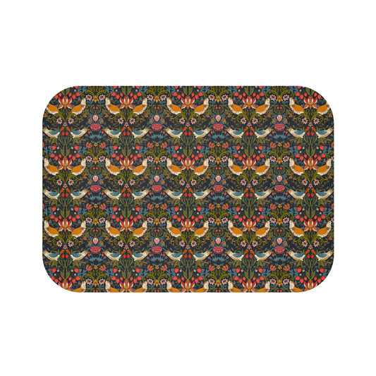 A rectangular microfibre bath mat with a colorful floral and bird pattern inspired by William Morris.