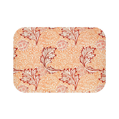 Rectangular microfibre bath mat with an orange and white floral pattern inspired by William Morris' Apple Collection.