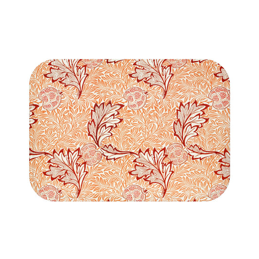 Rectangular microfibre bath mat with an orange and white floral pattern inspired by William Morris' Apple Collection.