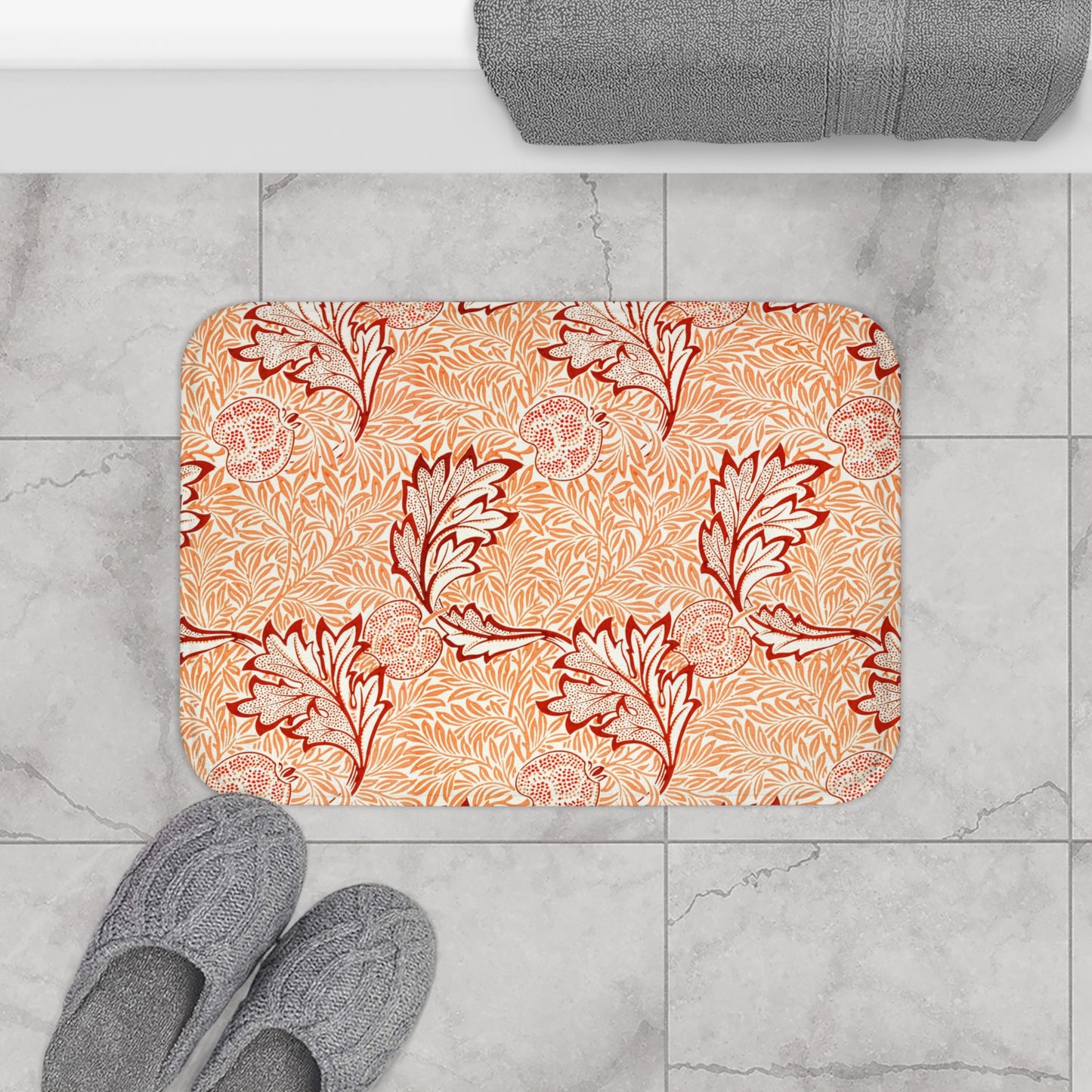 Rectangular microfibre bath mat with an orange and white floral pattern inspired by William Morris' Apple Collection.