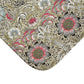 A rectangular microfibre bath mat with a floral pattern inspired by William Morris, predominantly in beige, green and pink colours.
