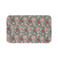 Microfibre bath mat with a floral pattern in shades of pink and green on a blue background, with a textured and non-slip appearance.