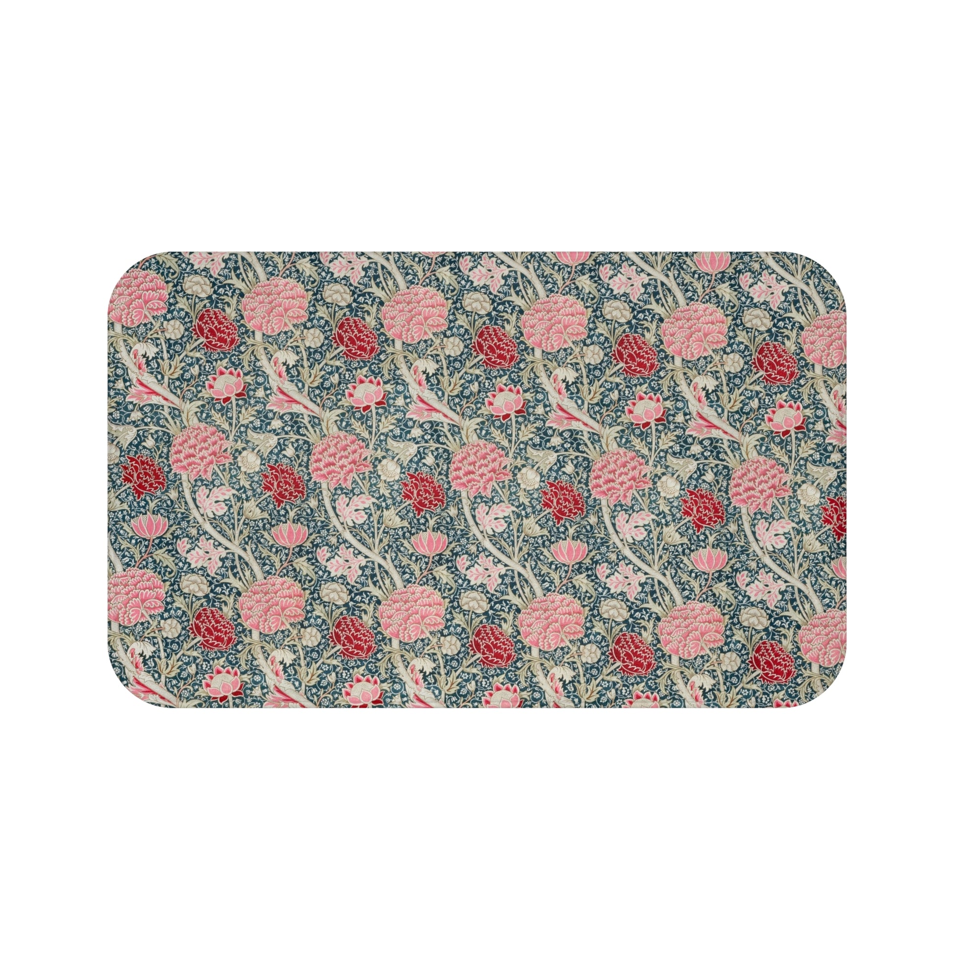 Microfibre bath mat with a floral pattern in shades of pink and green on a blue background, with a textured and non-slip appearance.