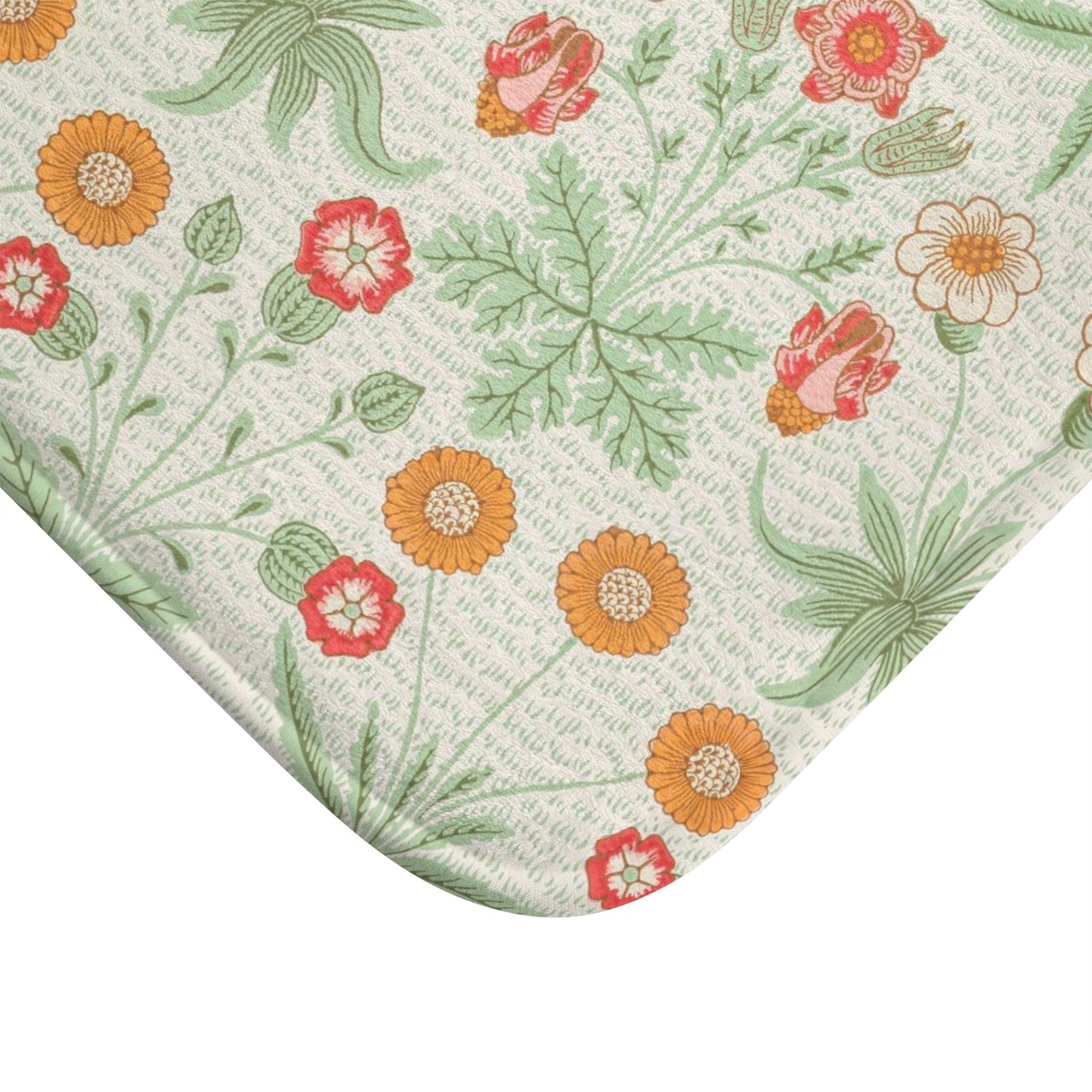 A rectangular microfibre bath mat with a floral pattern inspired by William Morris, featuring colours predominantly in green and orange.