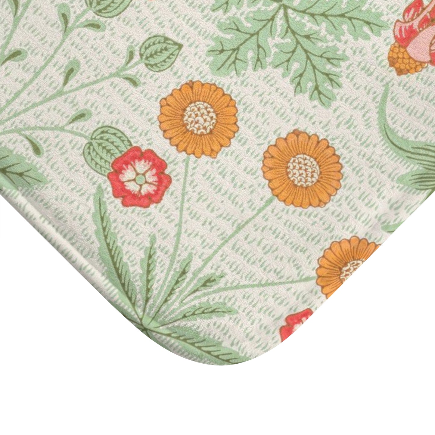 A rectangular microfibre bath mat with a floral pattern inspired by William Morris, featuring colours predominantly in green and orange.