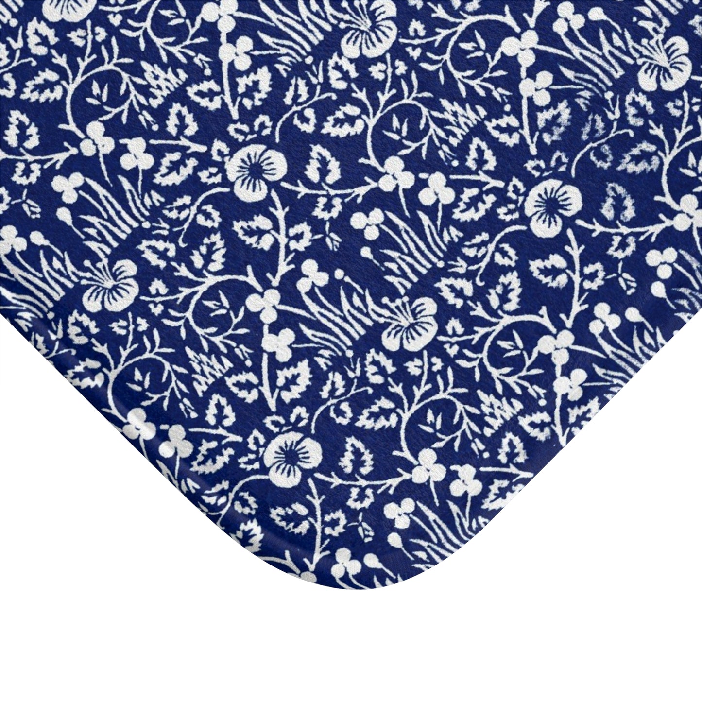 A rectangular microfibre bath mat with a blue floral pattern inspired by William Morris.