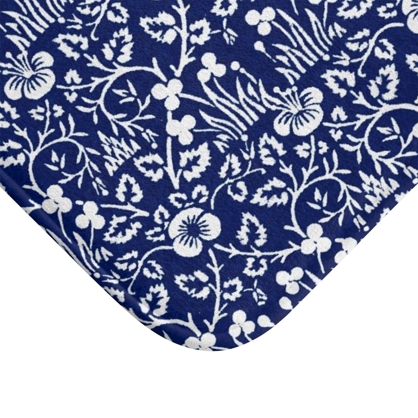 A rectangular microfibre bath mat with a blue floral pattern inspired by William Morris.