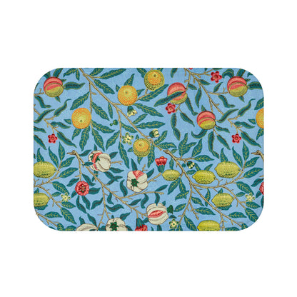 A rectangular microfibre bath mat with a floral pattern featuring fruits and leaves on a blue background.