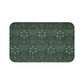 Rectangular microfibre bath mat with an intricate floral pattern in green and gold colors, with rounded edges and a non-slip black backing.