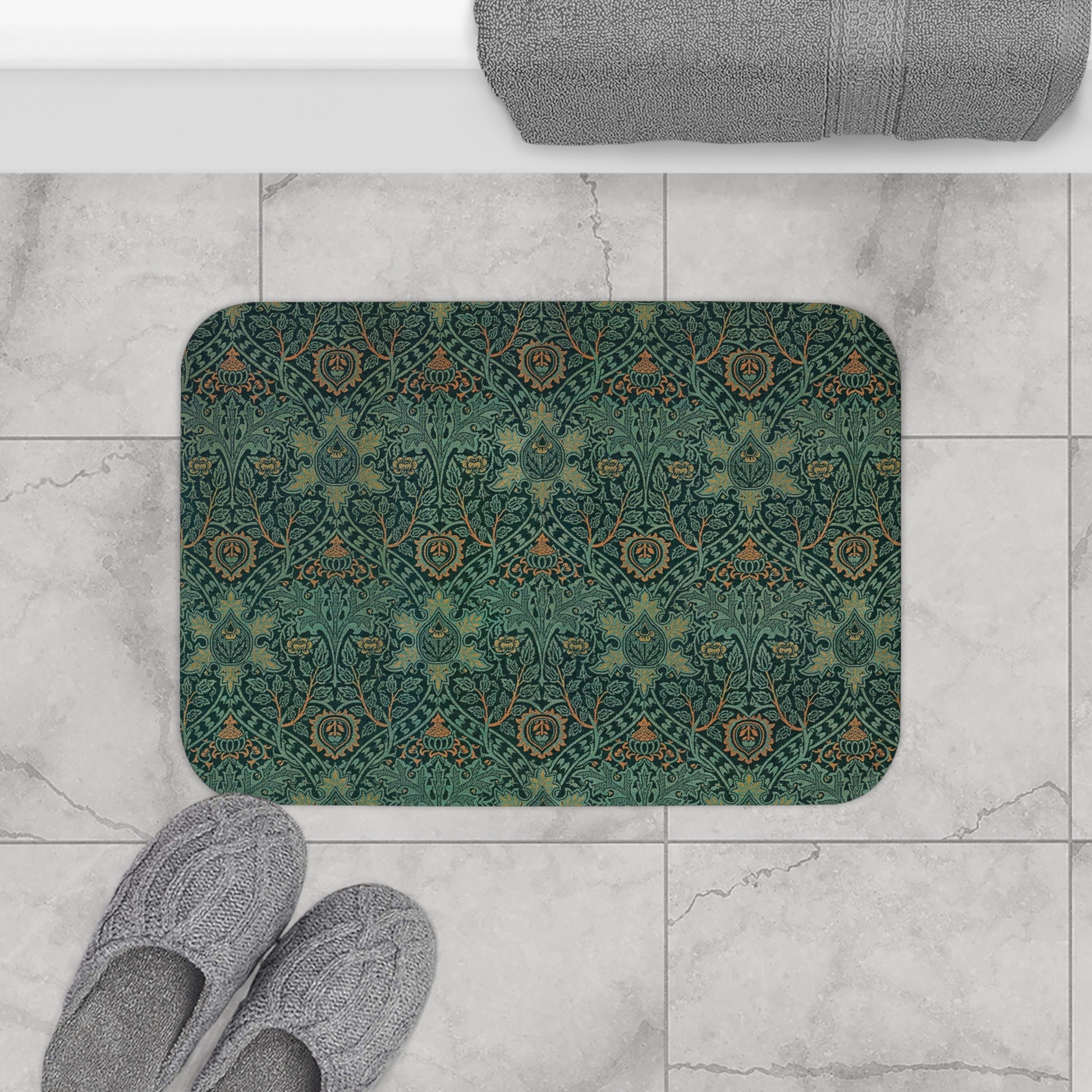 Rectangular microfibre bath mat with an intricate floral pattern in green and gold colours, with rounded edges and a non-slip black backing from William Morris.