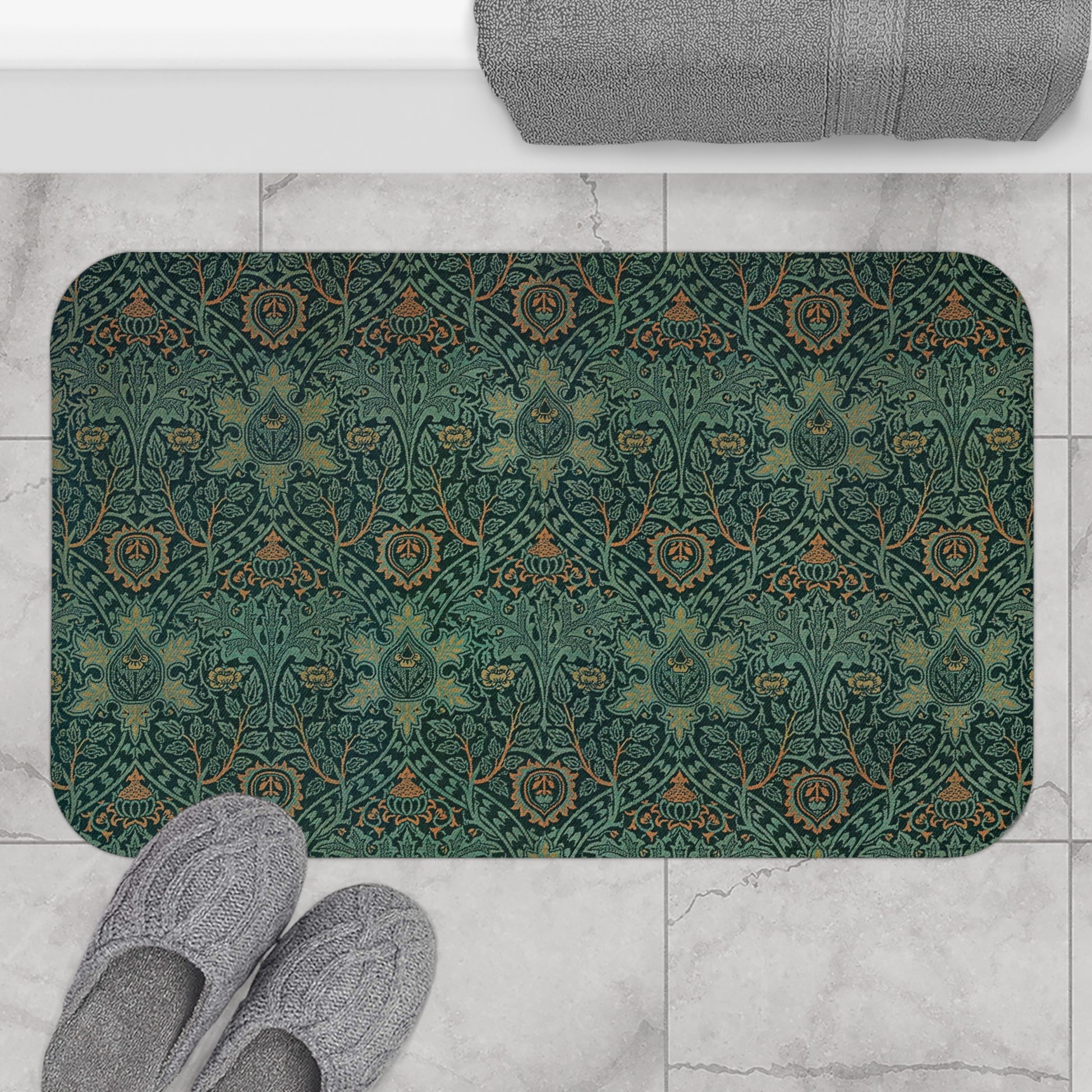 Rectangular microfibre bath mat with an intricate floral pattern in green and gold colours, with rounded edges and a non-slip black backing from William Morris.