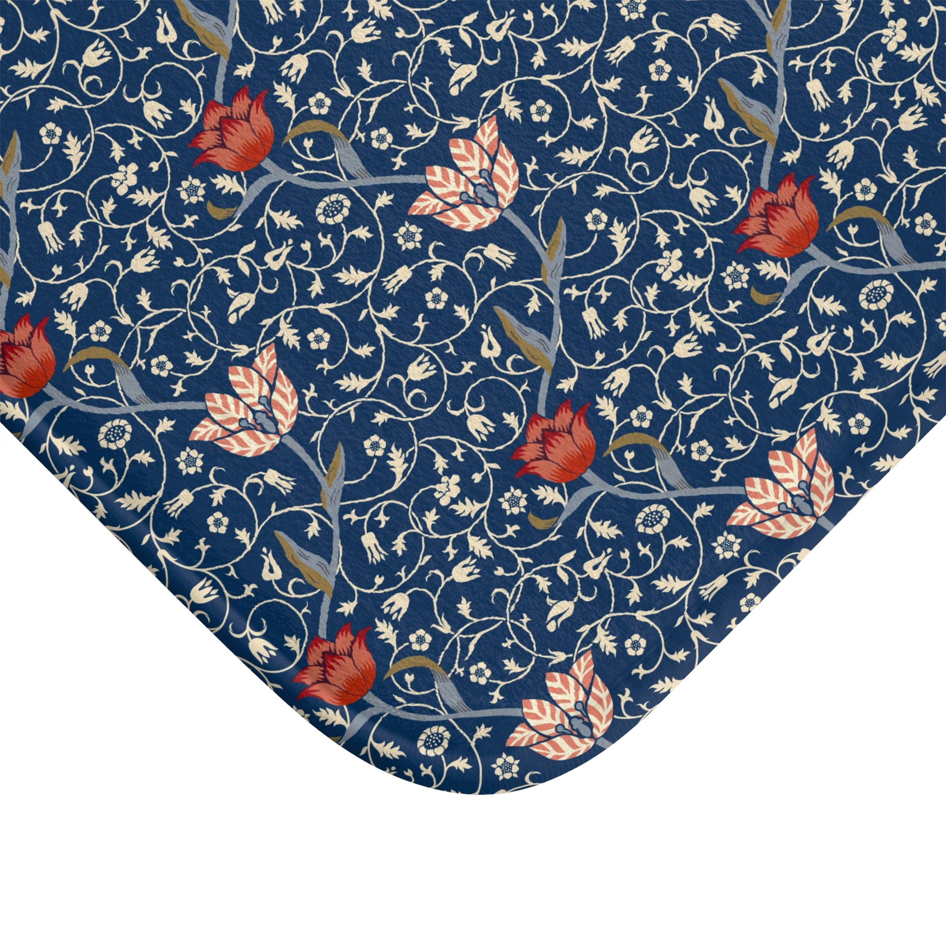 A rectangular microfibre bath mat with a floral pattern inspired by William Morris, predominantly blue with red and white accents.