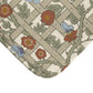 A microfibre bath mat with a floral pattern inspired by William Morris, featuring a grid of flowers and leaves.