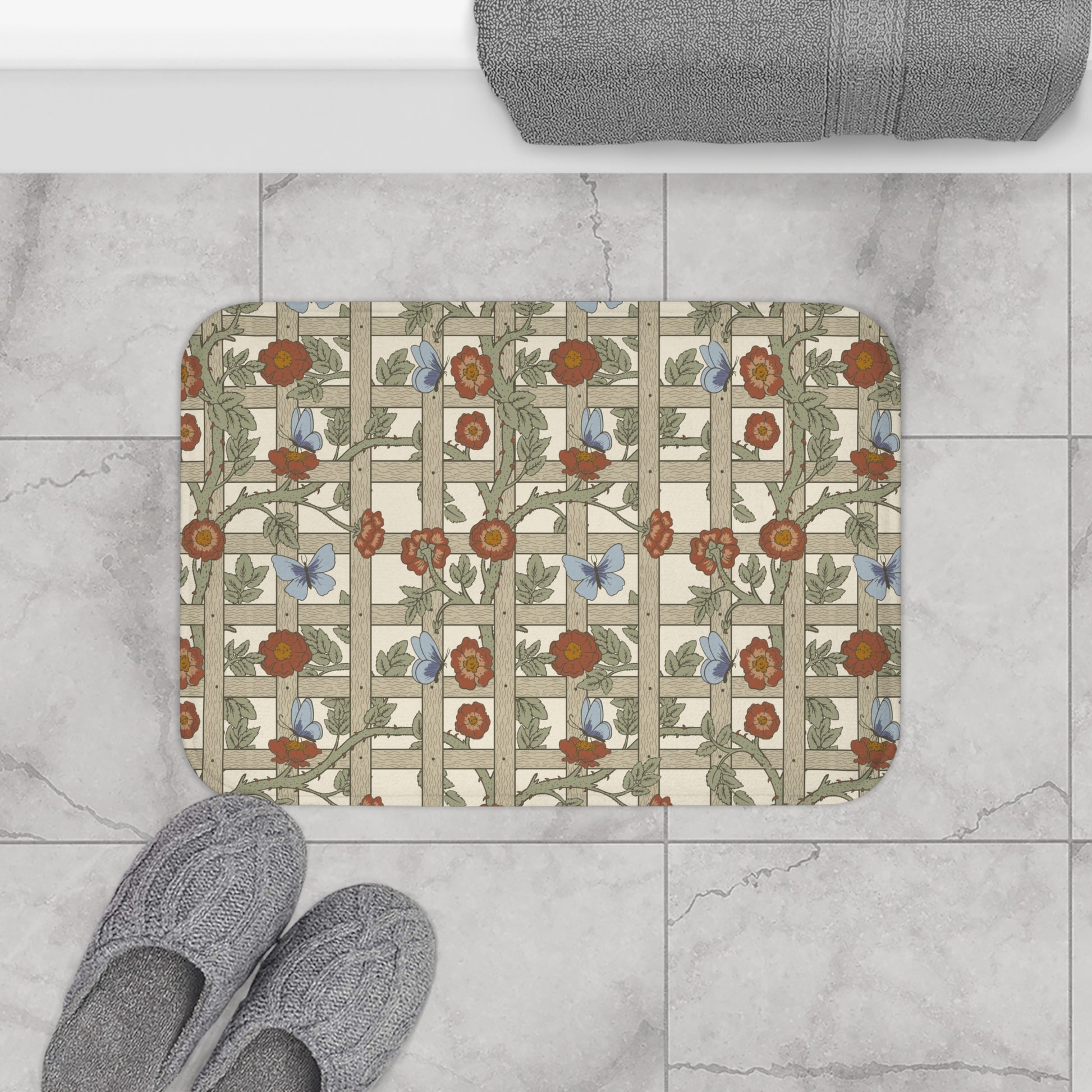 A microfibre bath mat with a floral pattern inspired by William Morris, featuring a grid of flowers and leaves.