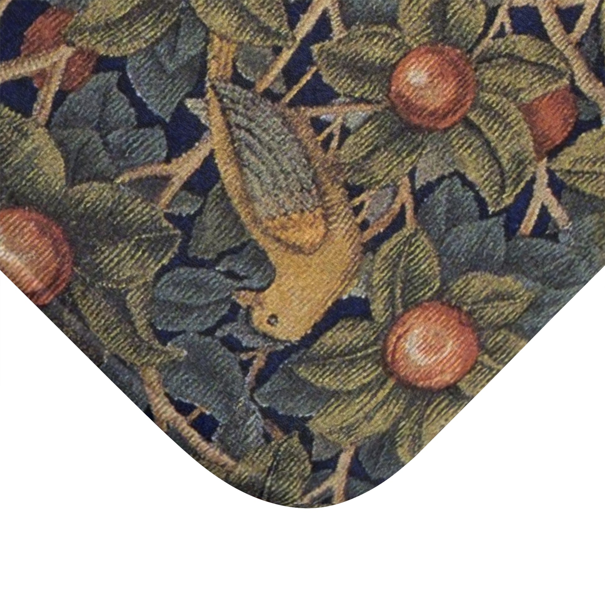 Close-up of a patterned fabric with leaves and fruits on a white background