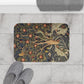 Decorative doormat with nature-themed design on a tiled floor with slippers.