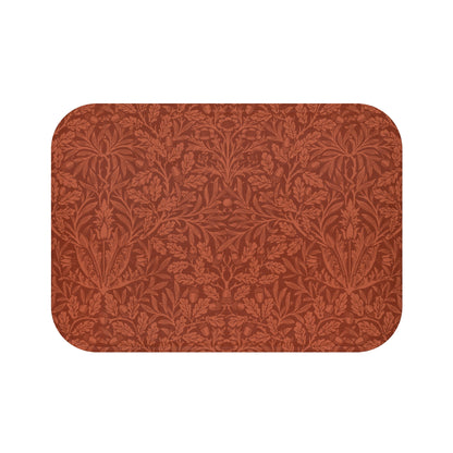 Rectangular microfibre bath mat in a rust colour with a floral pattern inspired by William Morris.