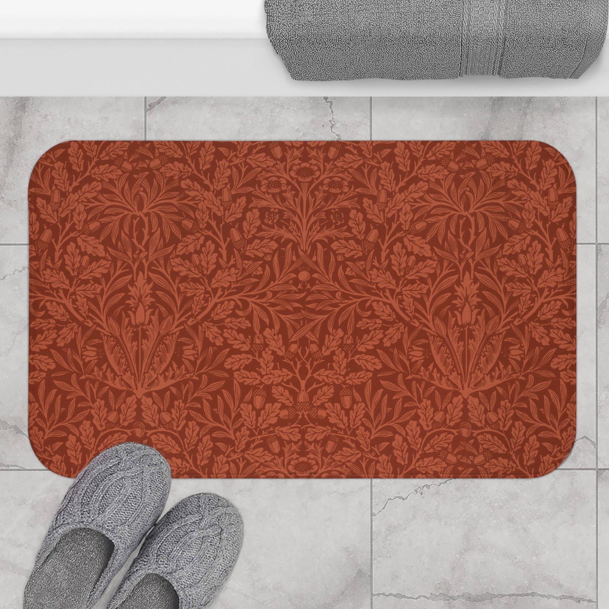 Rectangular microfibre bath mat in a rust colour with a floral pattern inspired by William Morris.