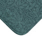 A rectangular microfibre bath mat in teal colour, featuring a floral pattern inspired by William Morris.