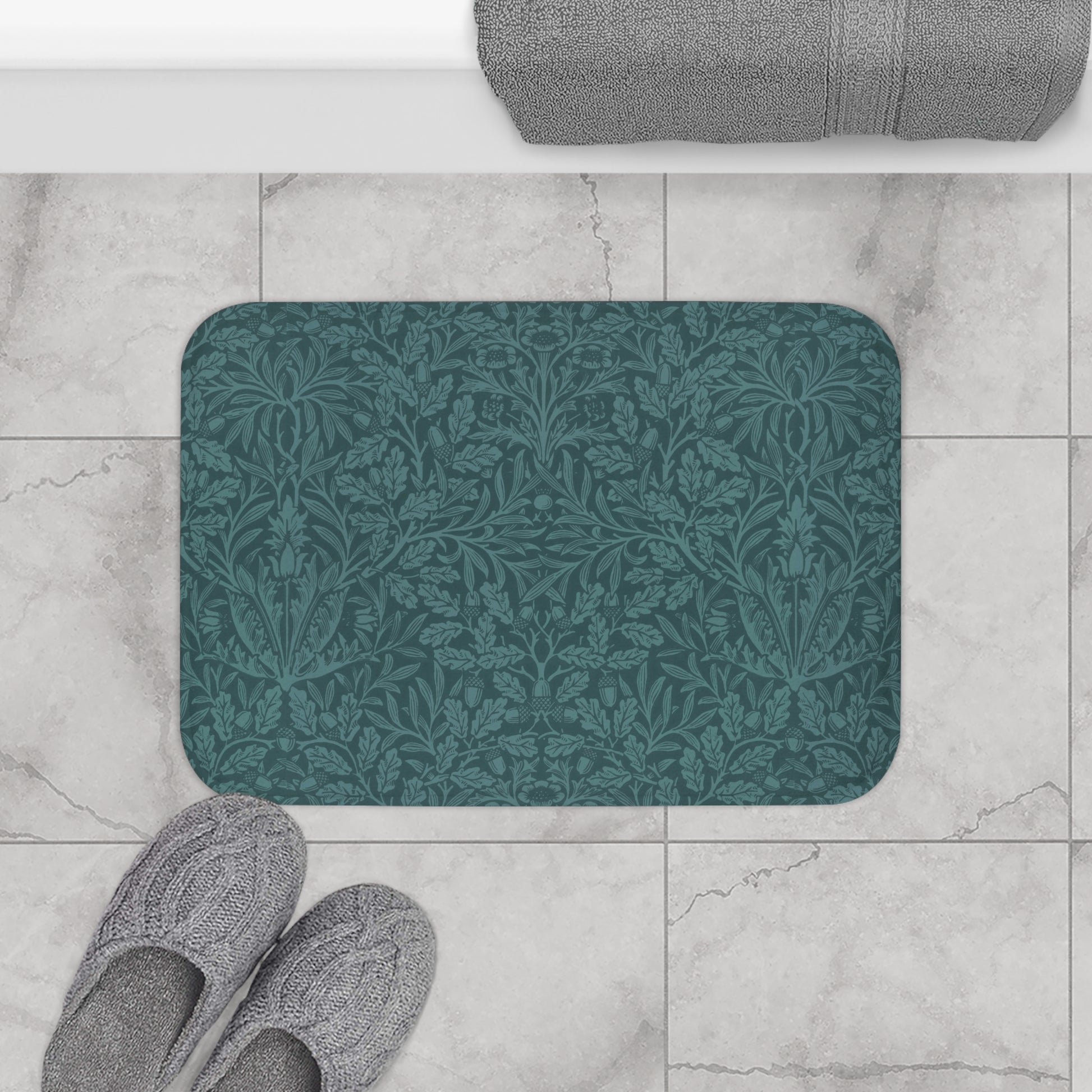 A rectangular microfibre bath mat in teal colour, featuring a floral pattern inspired by William Morris.